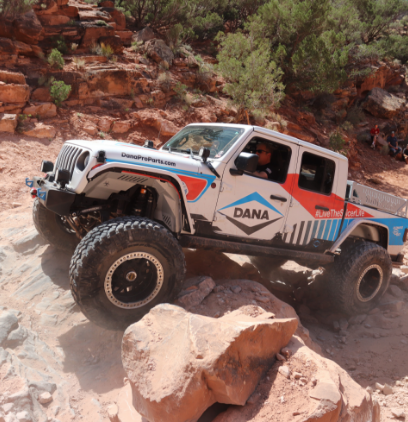 A Dana-branded Jeep on a mountain rock
